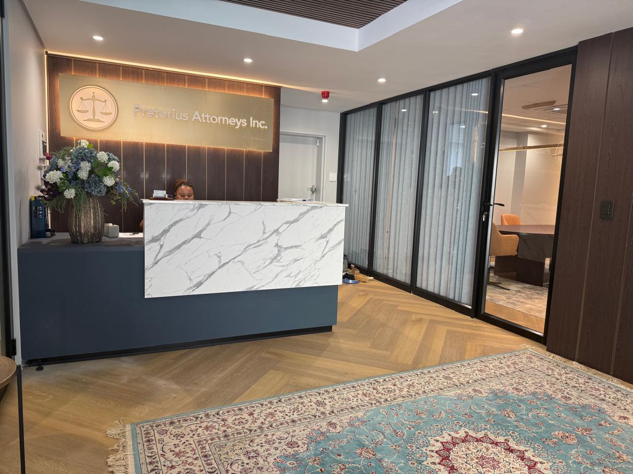 Attorneys' Reception Desk & Feature Wall — custom cabinetry by Modern Kitchens & Cupboards