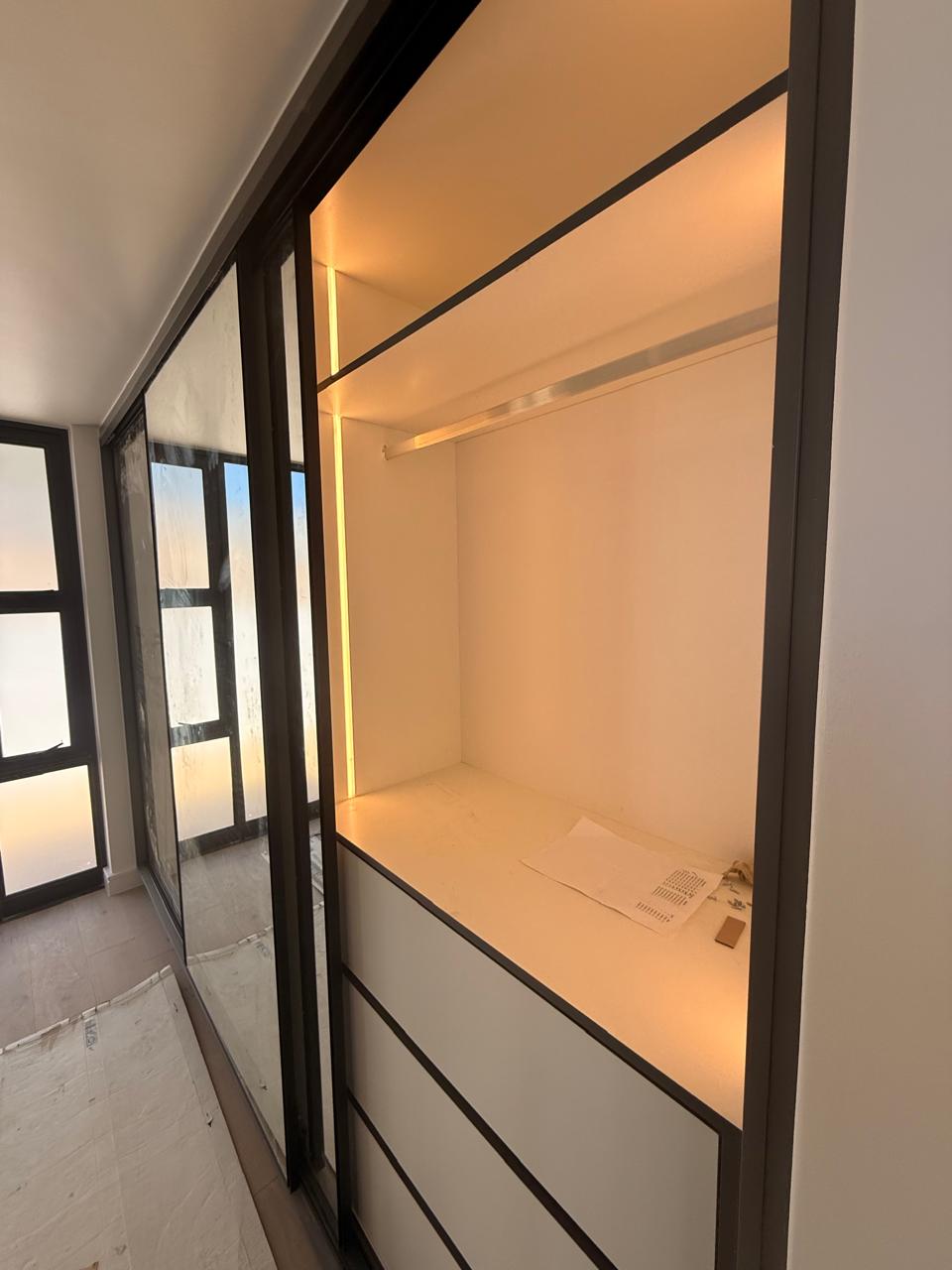 Lit Sliding-Door Wardrobe — custom cabinetry by Modern Kitchens & Cupboards