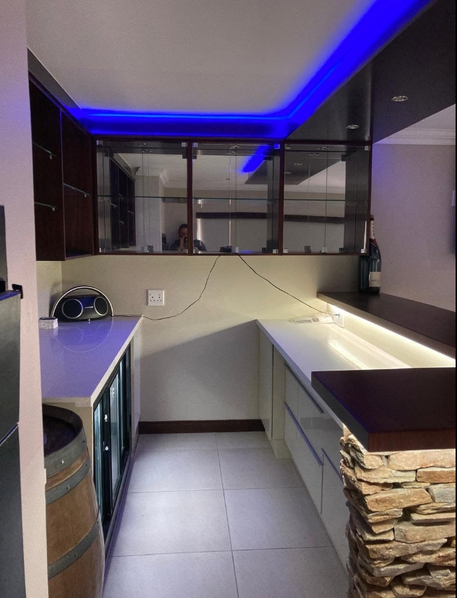 Stone & Mirror Entertainment Bar — custom cabinetry by Modern Kitchens & Cupboards