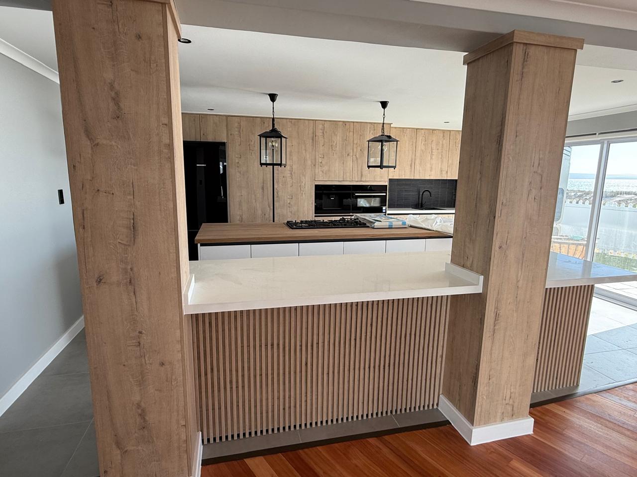 Oak Kitchen with Slatted Bar Peninsula — custom cabinetry by Modern Kitchens & Cupboards